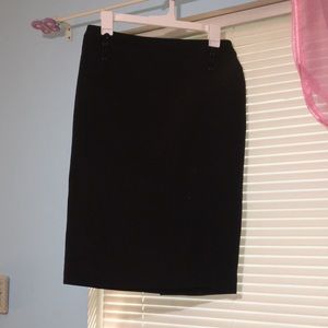 Black pencil skirt with buttons on the side.